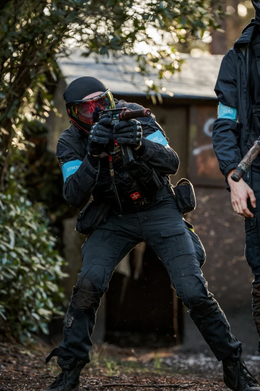 two man in black and blue clothing with masks on