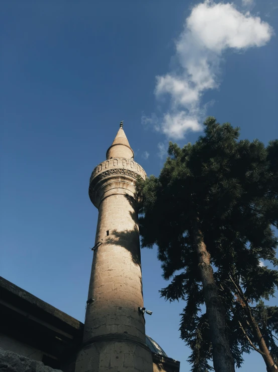 a tall stone tower sits on top of a building