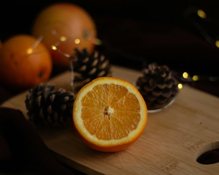 an orange and two cones on a wooden board