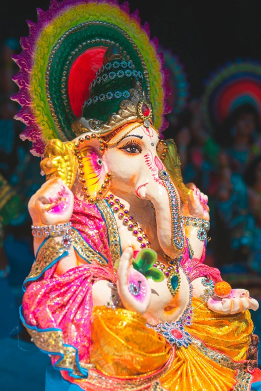 colorful elephant statue with ornate decoration in front of spectators