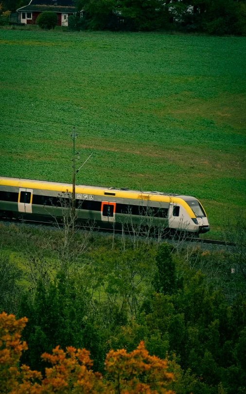 an electric train going through the countryside