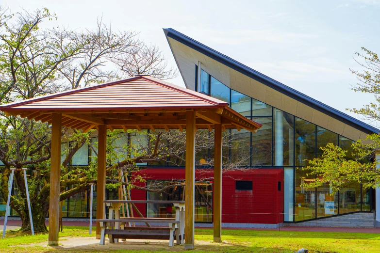 a large gazebo in front of a building with an open porch