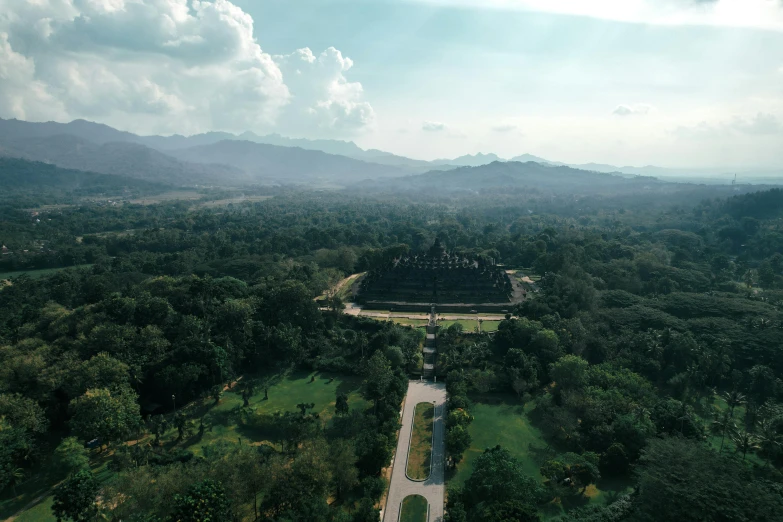 an aerial view of a tropical forest with mountains