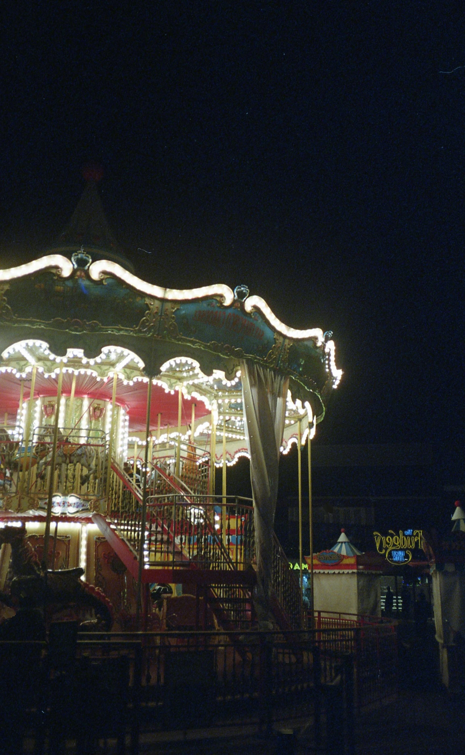 a merry go round and people walking around at night