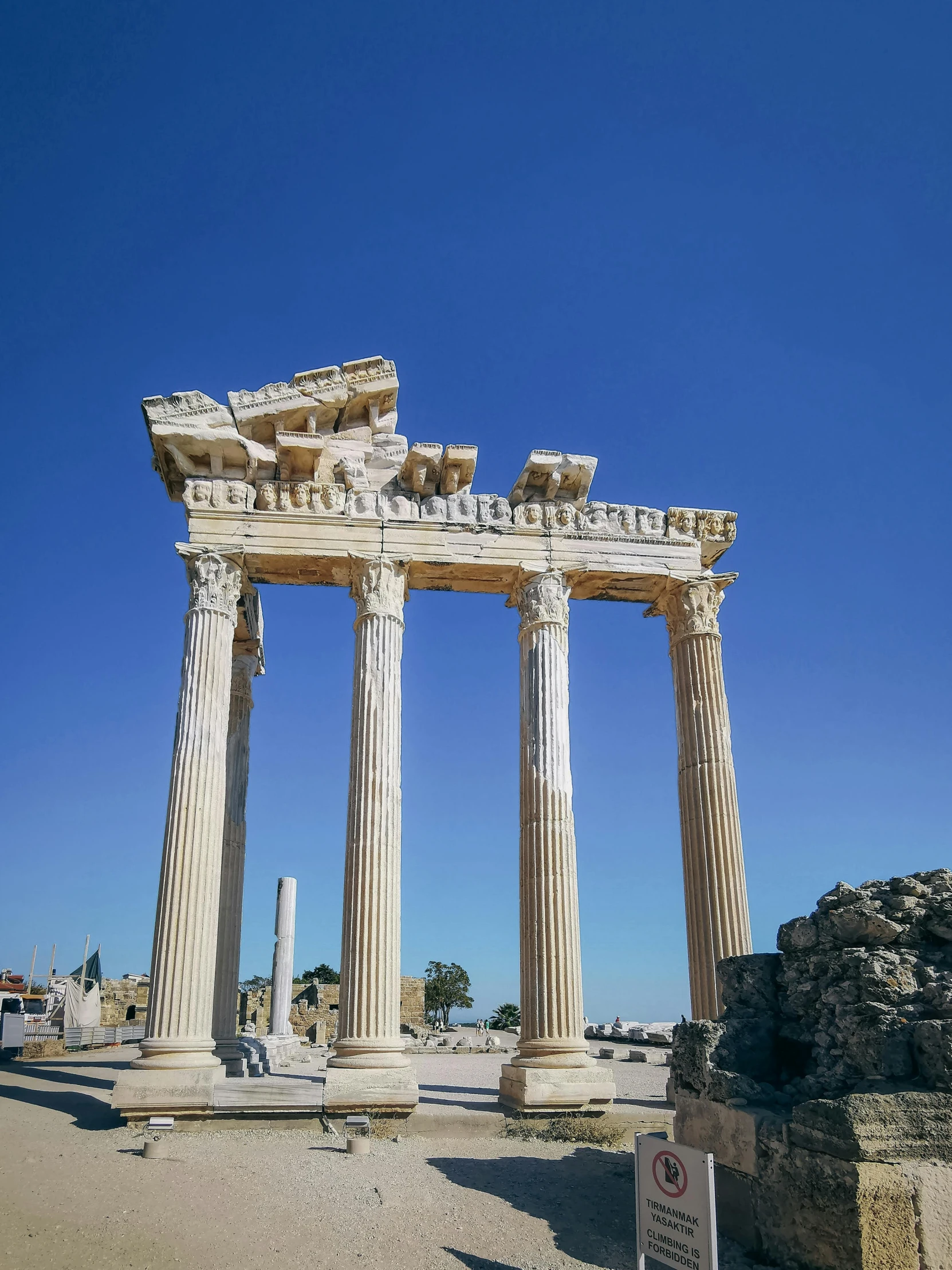 three very large roman columns on the ground