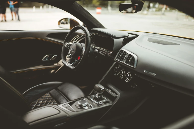 a car dashboard with people standing around