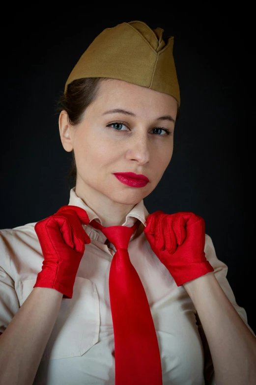 a woman wearing a hat and red gloves