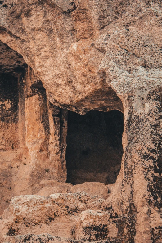 two small caves in the rock face of a hill