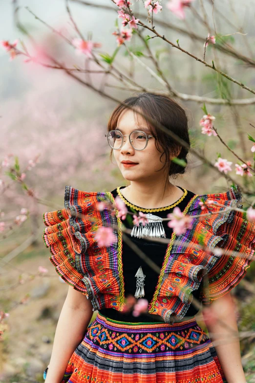 a woman is looking around while wearing a dress