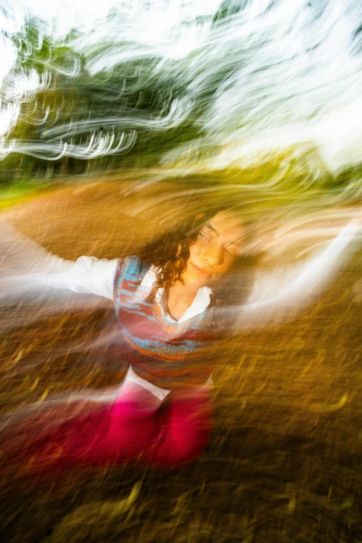 blurred pograph of woman wearing colorful clothing holding a white frisbee