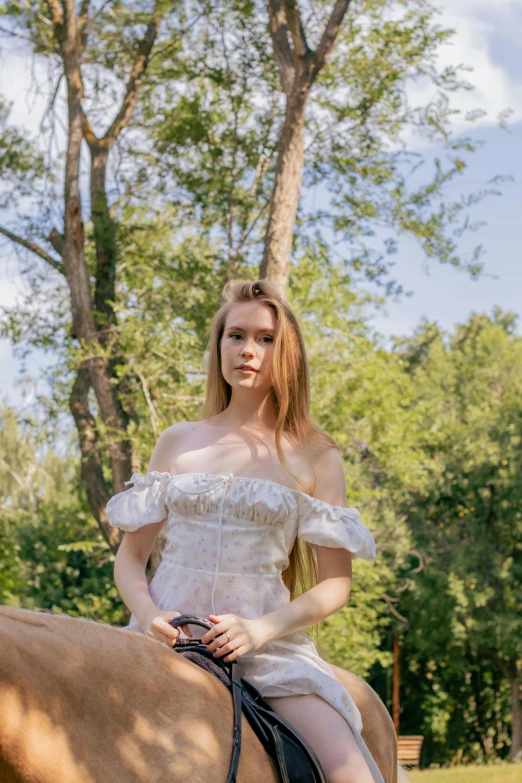 young lady sitting on the back of a horse