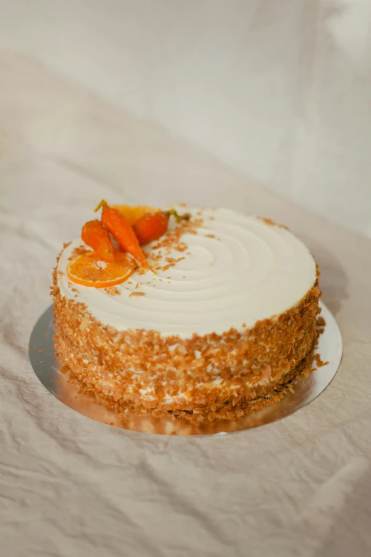 a frosted cake topped with fresh carrots and cream