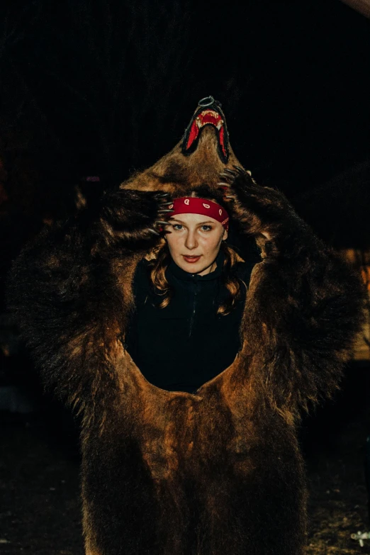 a woman is wearing a furry bear outfit