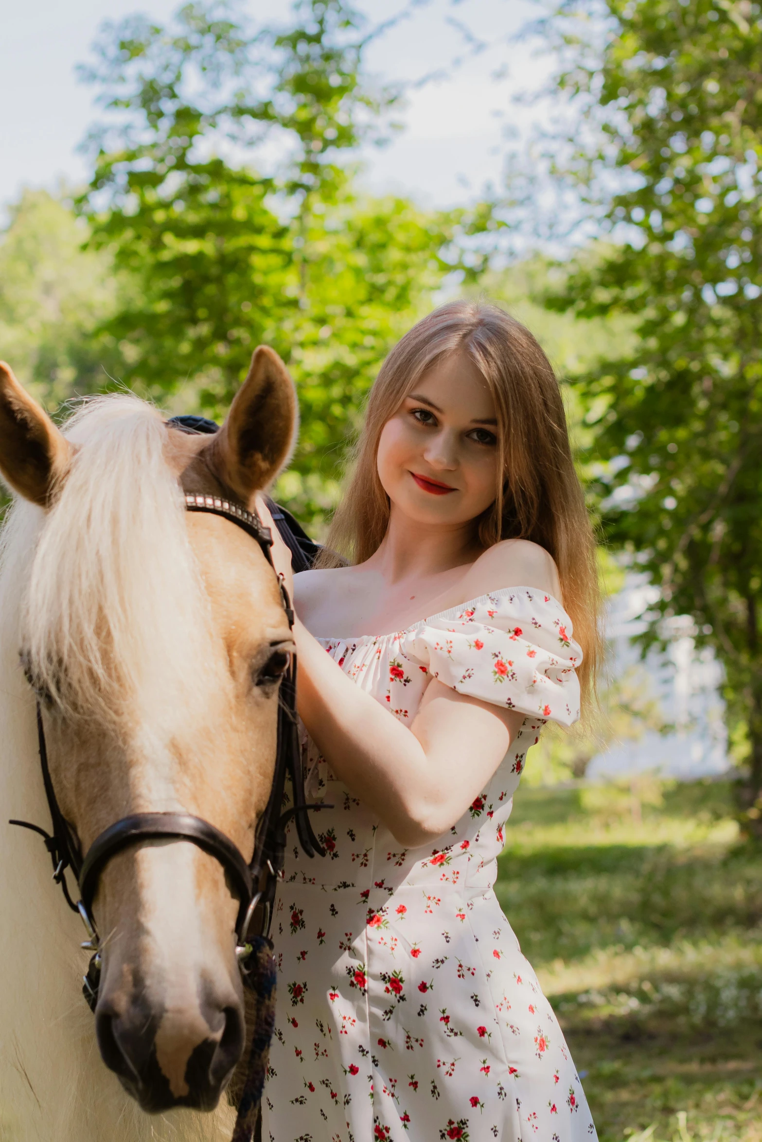 a girl in a white dress stands with her horse