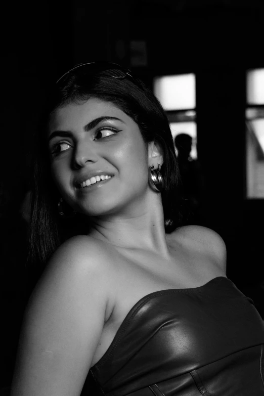 a woman smiles as she sits in a room