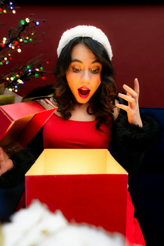 a woman standing next to some christmas presents