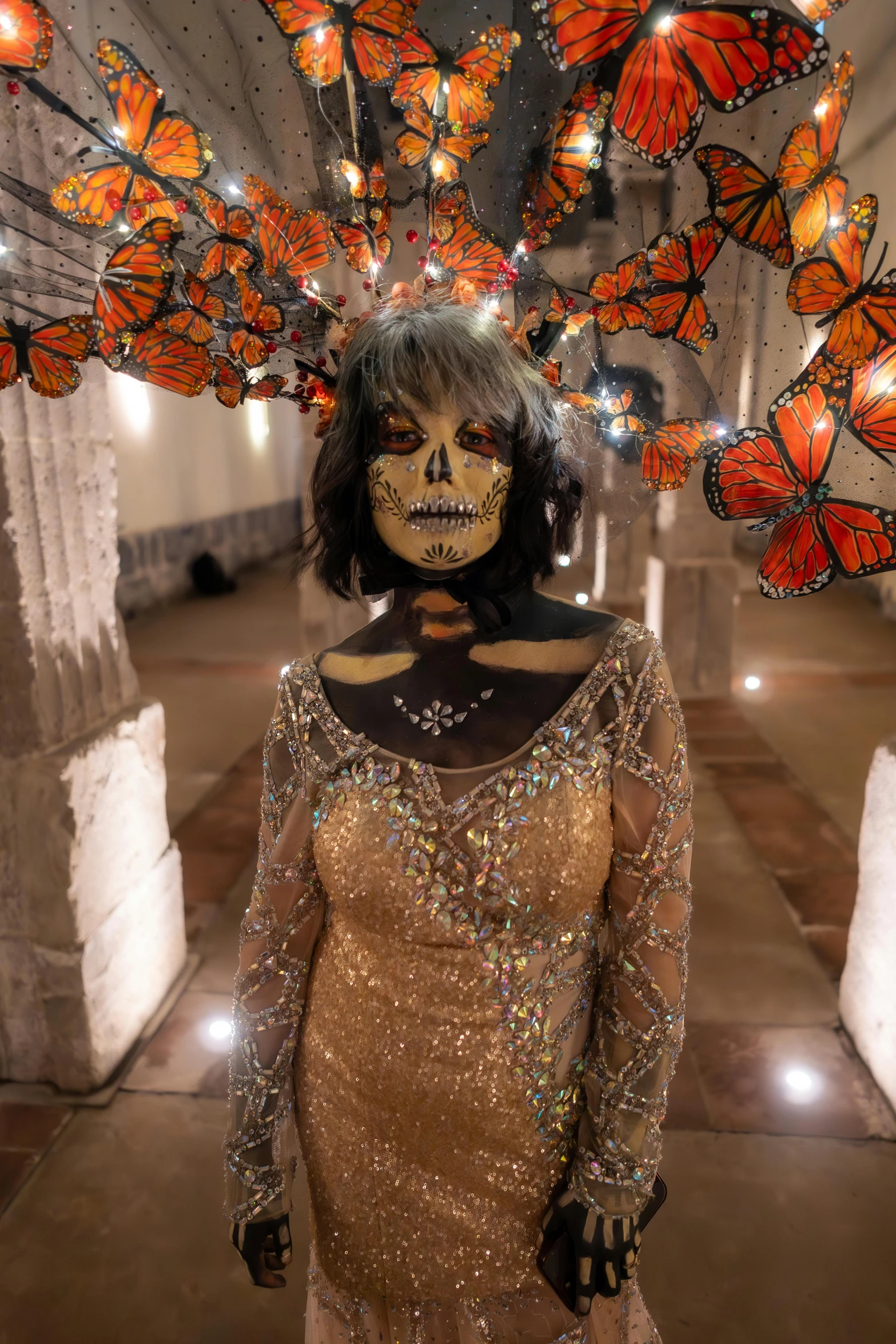 a woman with makeup painted and erfly wings as headdress