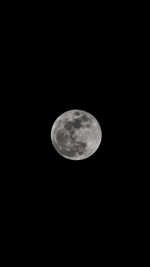 the moon as it appears to be overcast in the night sky