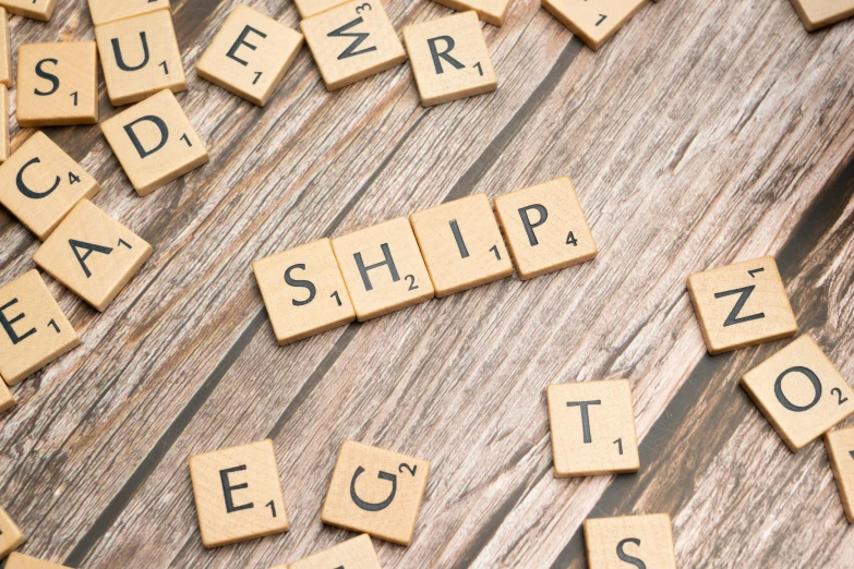 the scrabble letters are set on a wooden surface