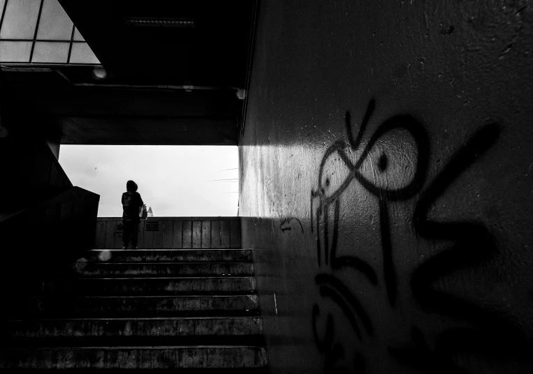 a person is walking down some stairs in the dark