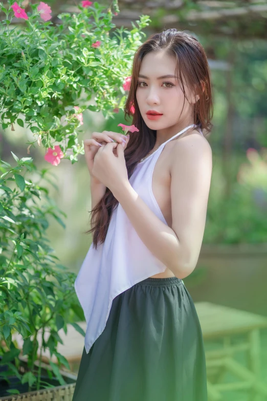 a woman is standing in front of a tree