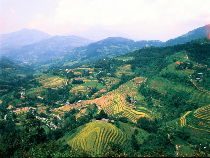 a village is perched on top of a large terraced hillside