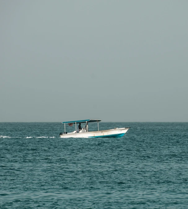 a motorboat with a cover is in the ocean