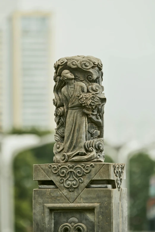 a statue on top of some stone outdoors