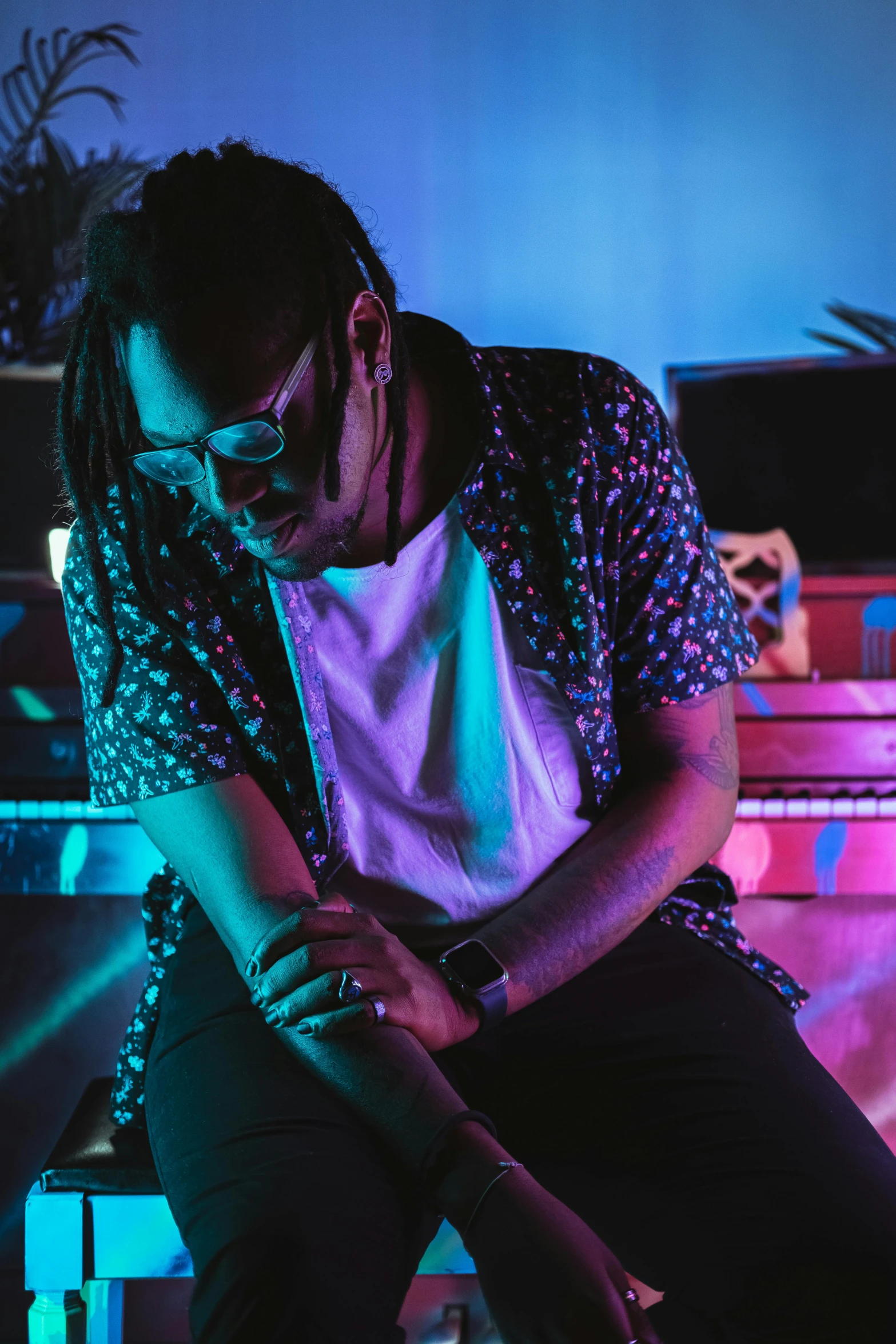 a man with dreadlocks and a colorful background