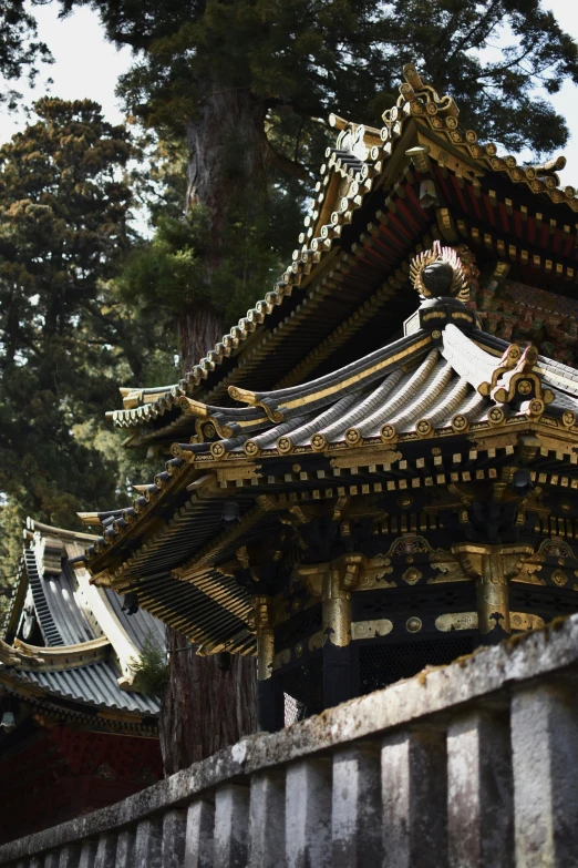 a building with two golden roof tops near a wall