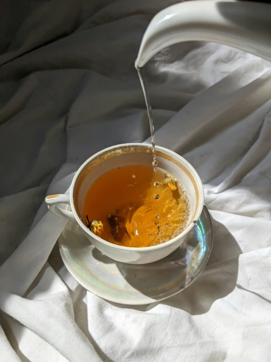 a teacup filled with a liquid of yellow color