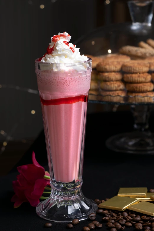 a small dessert has whipped cream in it and a red drink