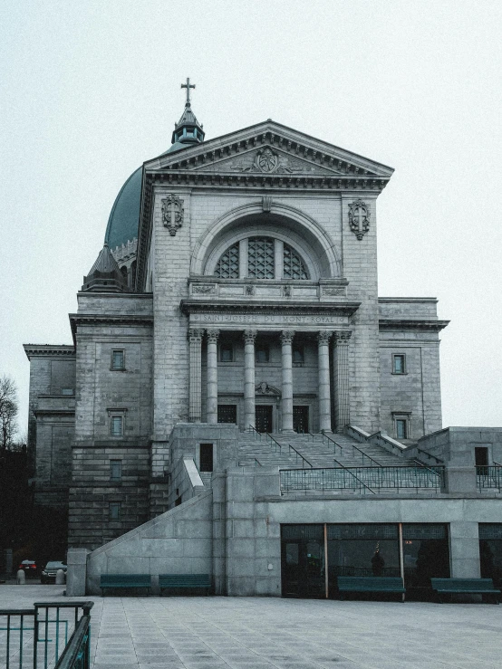 a large church with an arched doorway is next to a street