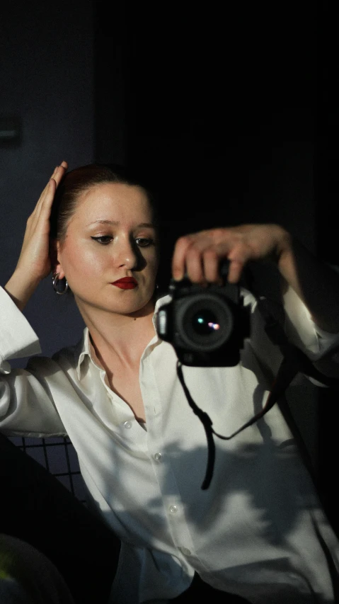 a lady holding a camera in her left hand