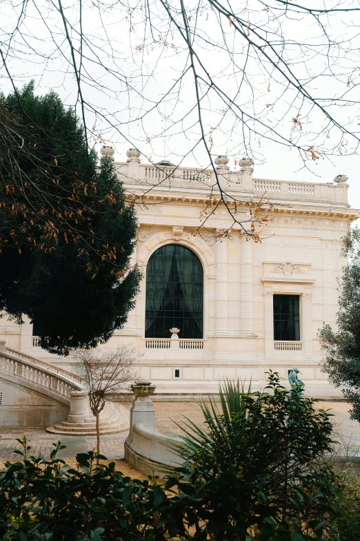 a large building with a lot of stairs and trees