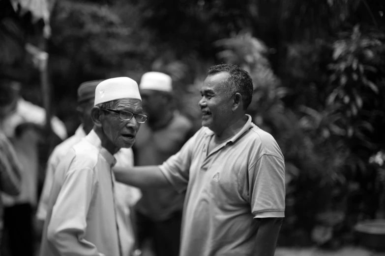 a couple of men standing around next to each other