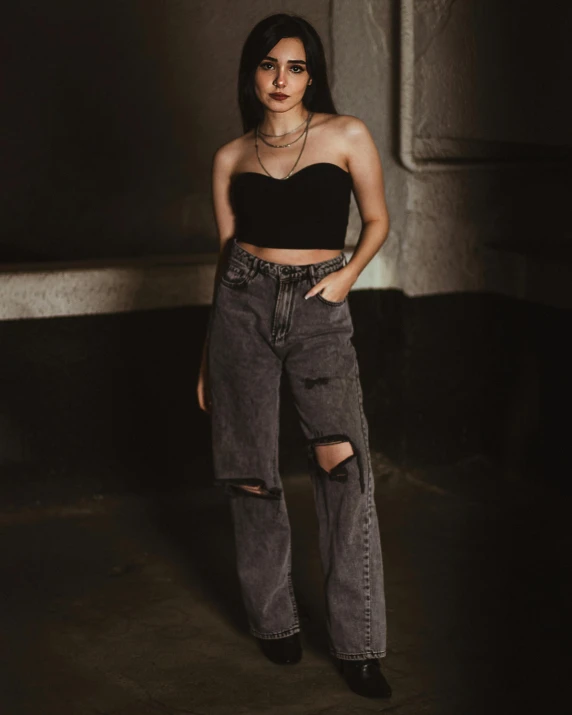 an attractive woman posing for a po in black crop top