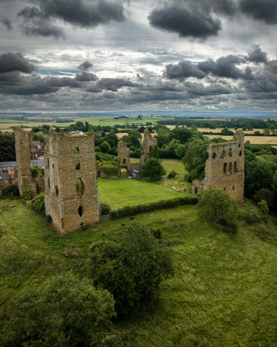 an old abandoned castle is in a field of green