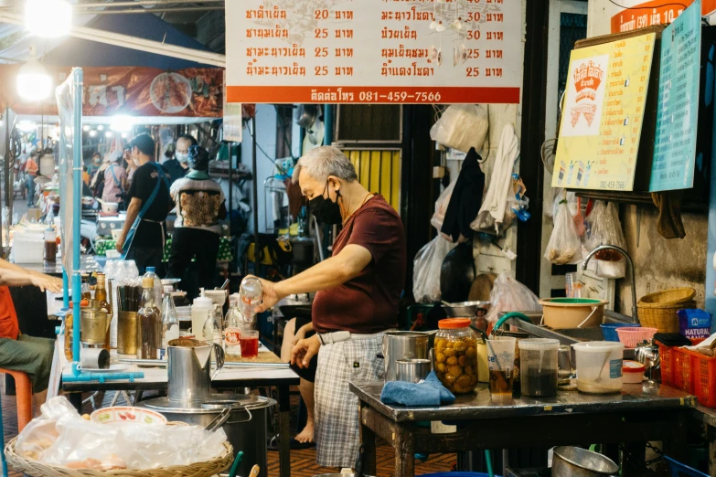 a couple of men working at an outdoor market