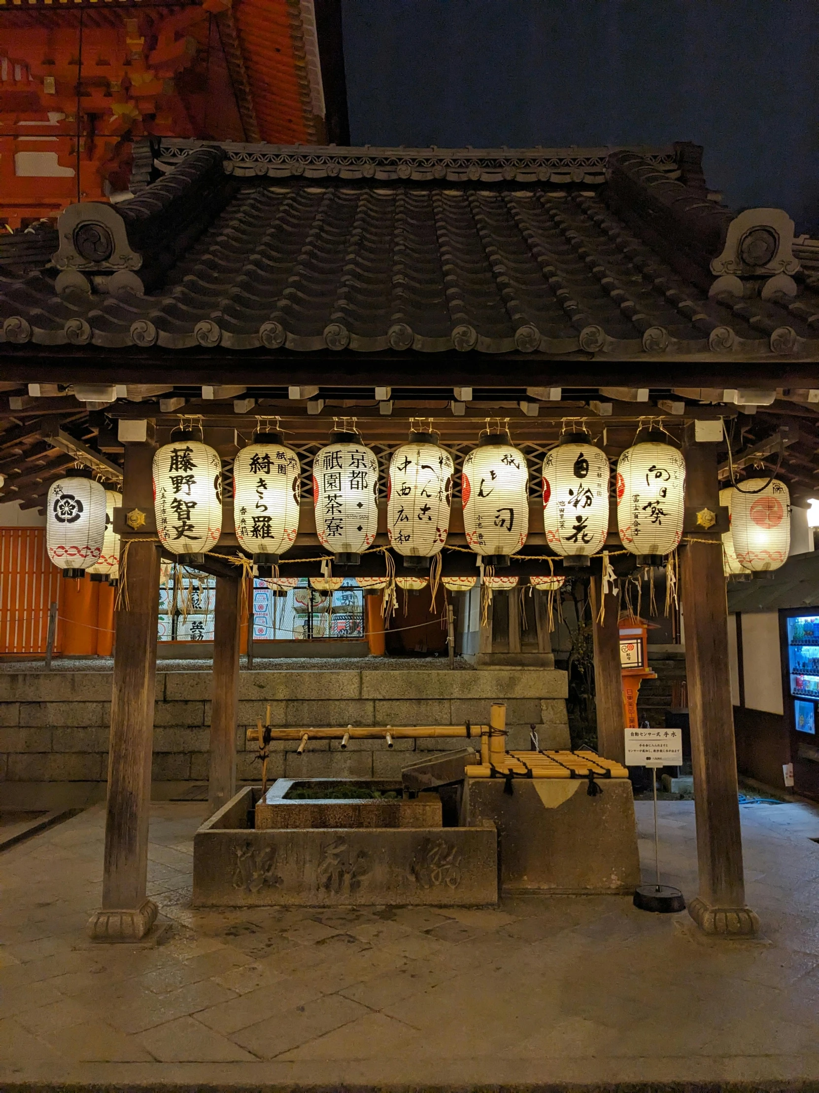 an ornate and artistic pavilion with hanging lanterns