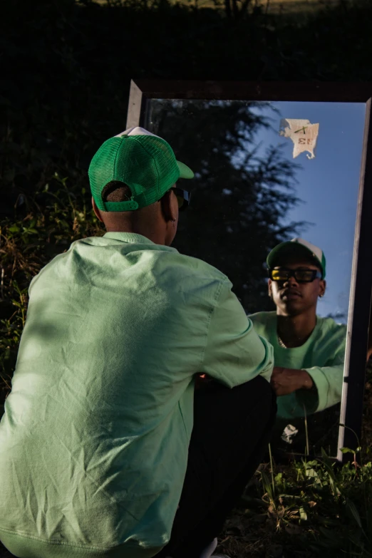 two men looking in a mirror at their reflection