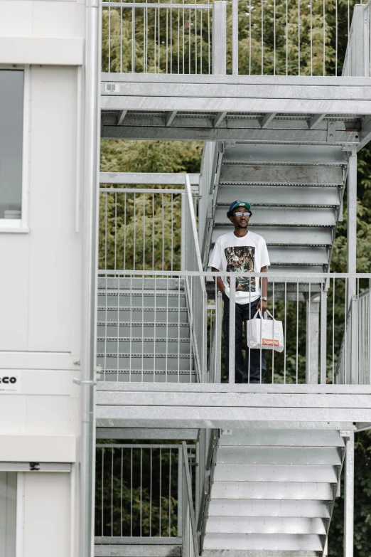 a man is standing on a stairway in the daytime