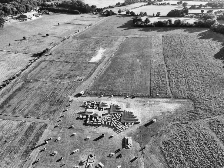 an aerial view of an agricultural land with buildings and a dirt road