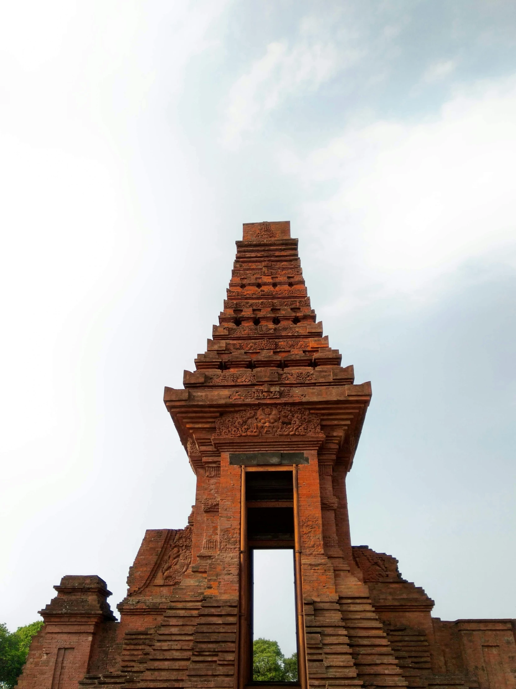 two elephants standing in front of a small pyramid