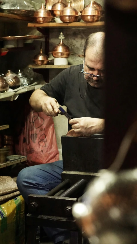 a man in a black shirt is working on an item