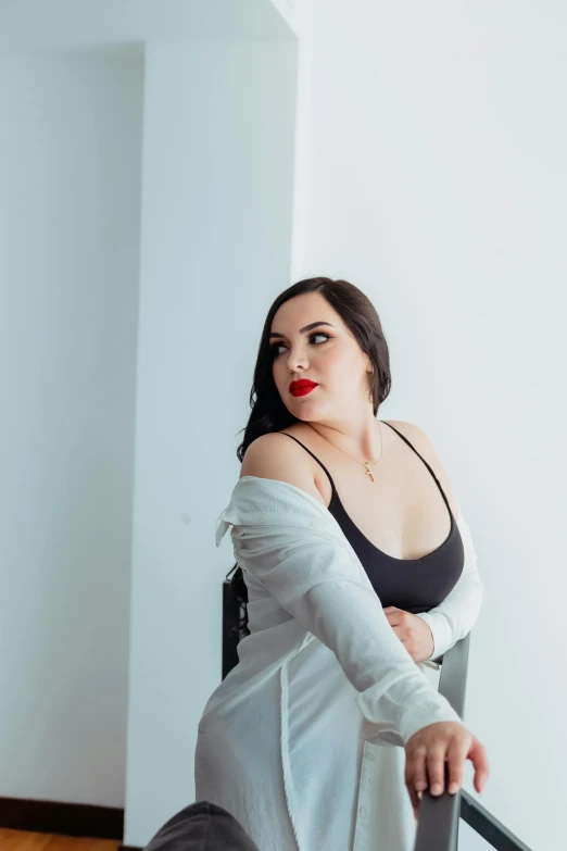 a woman leaning on the ledge and posing for a picture