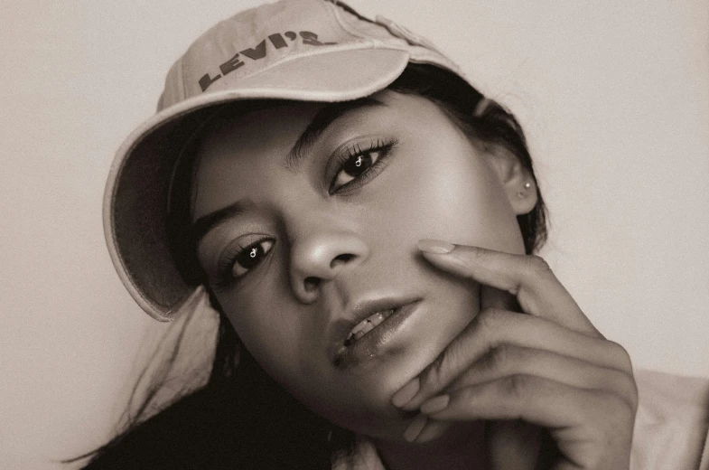 a black and white po of a woman in a baseball hat