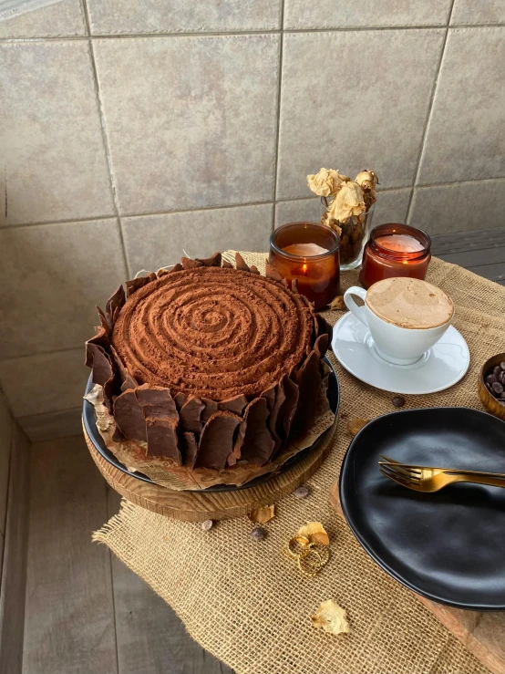 an elaborately decorated cake, with drinks and plates on the table