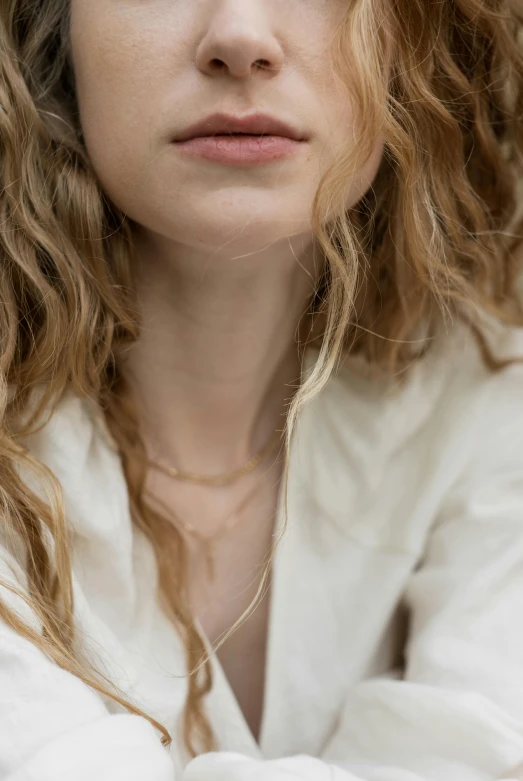 a woman is looking at the camera, with her arms folded up