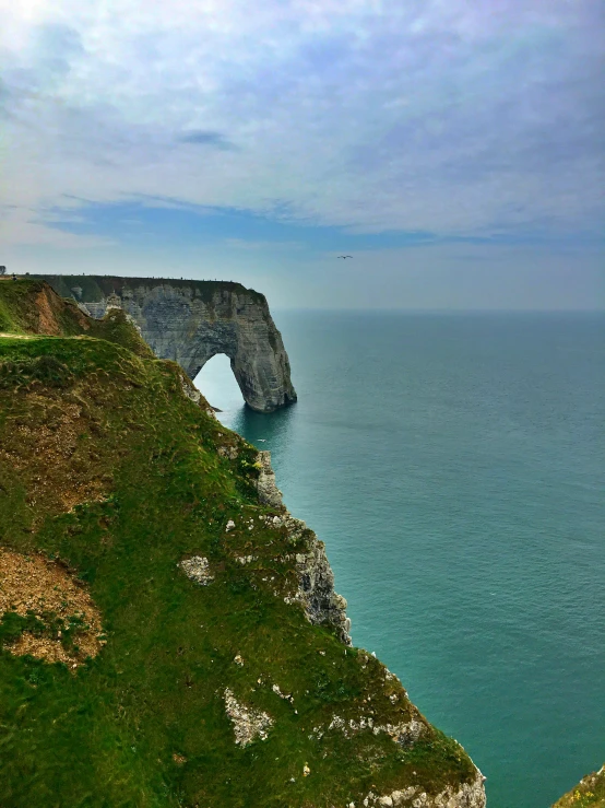 an image of a large ocean cliff on the edge of the sea